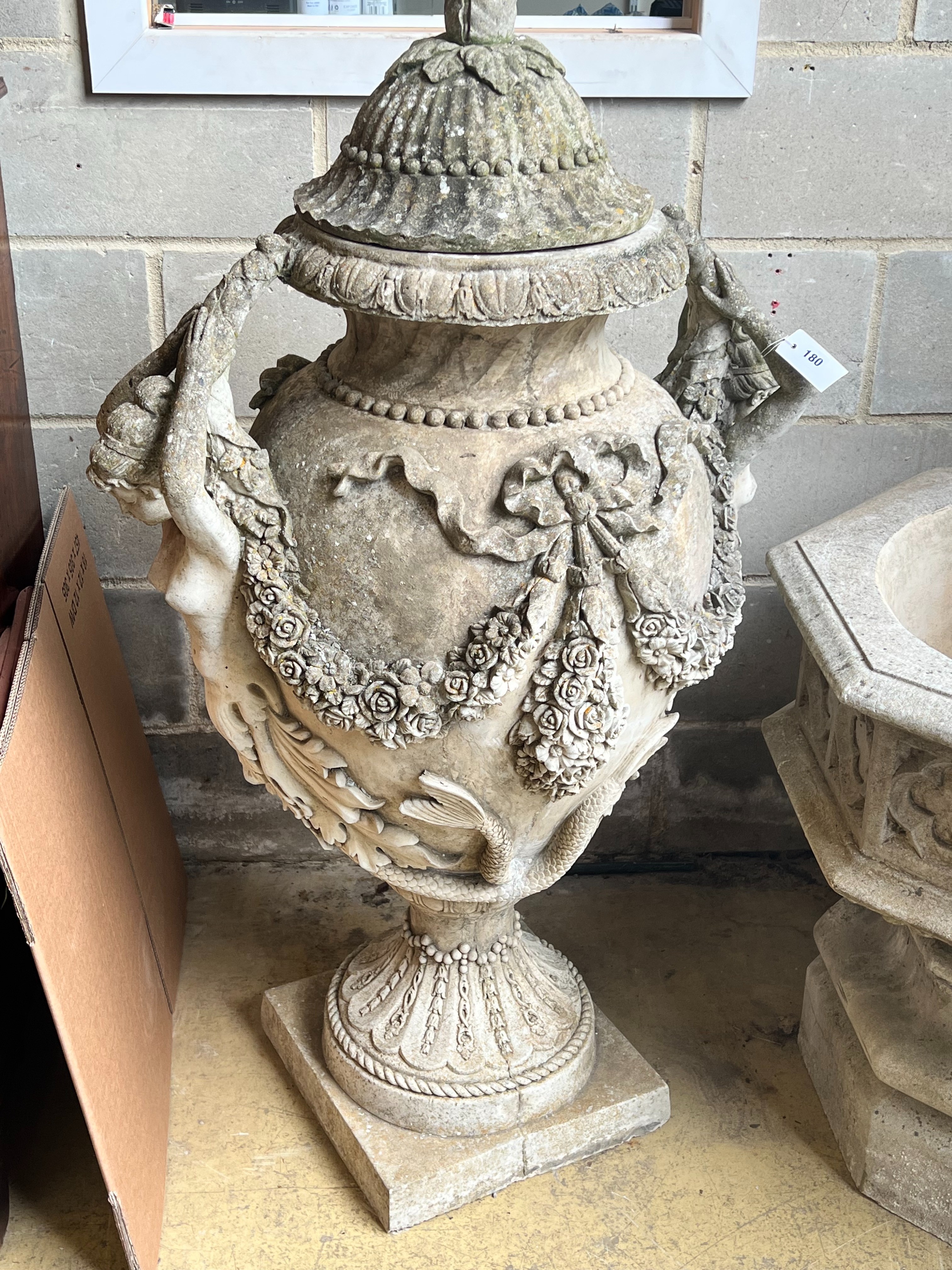 A large reconstituted stone lidded garden urn, with mermaid motif and floral swagged body, height 128cm